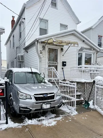 a front view of a house with parking space