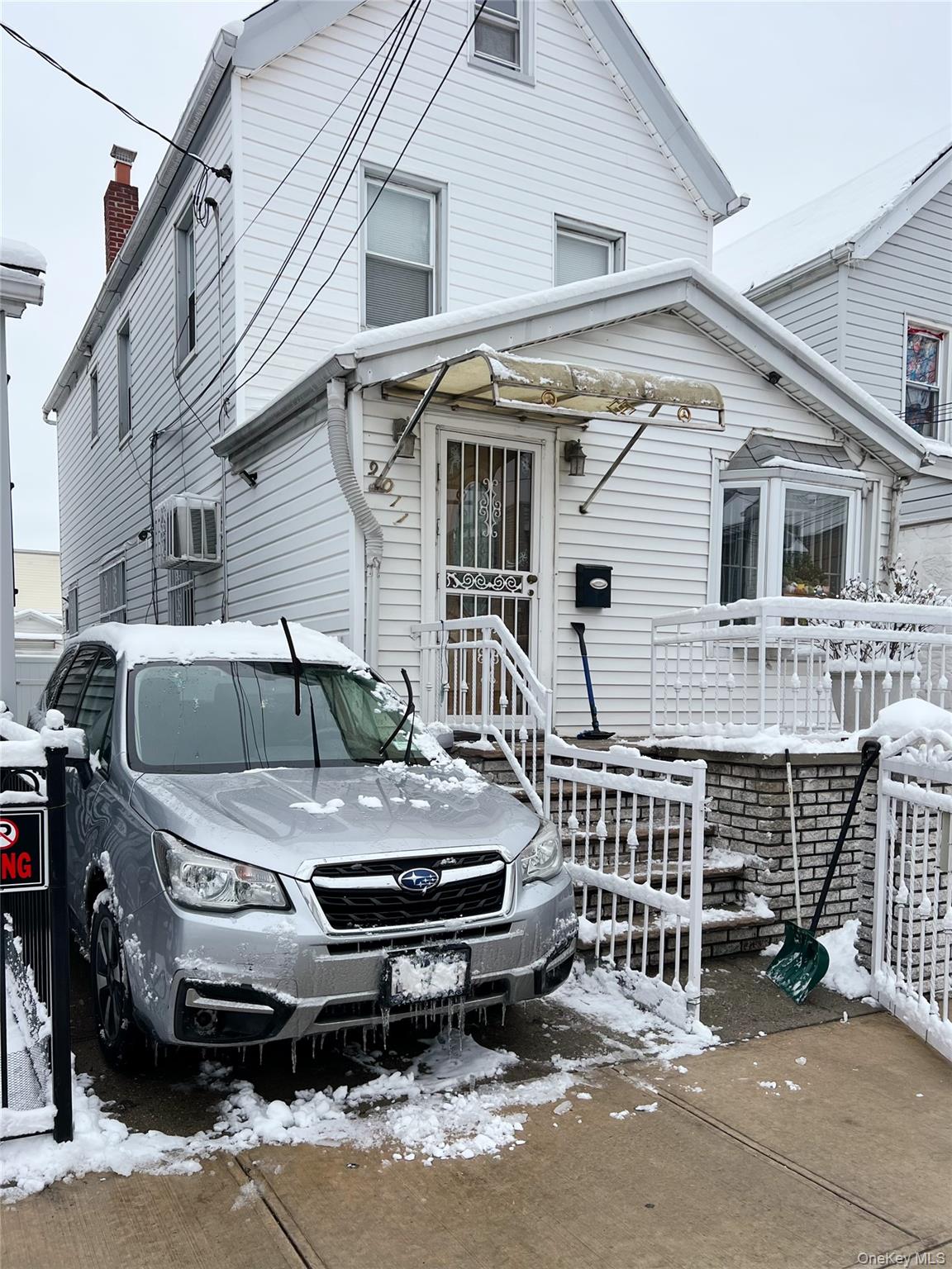 a front view of a house with parking space