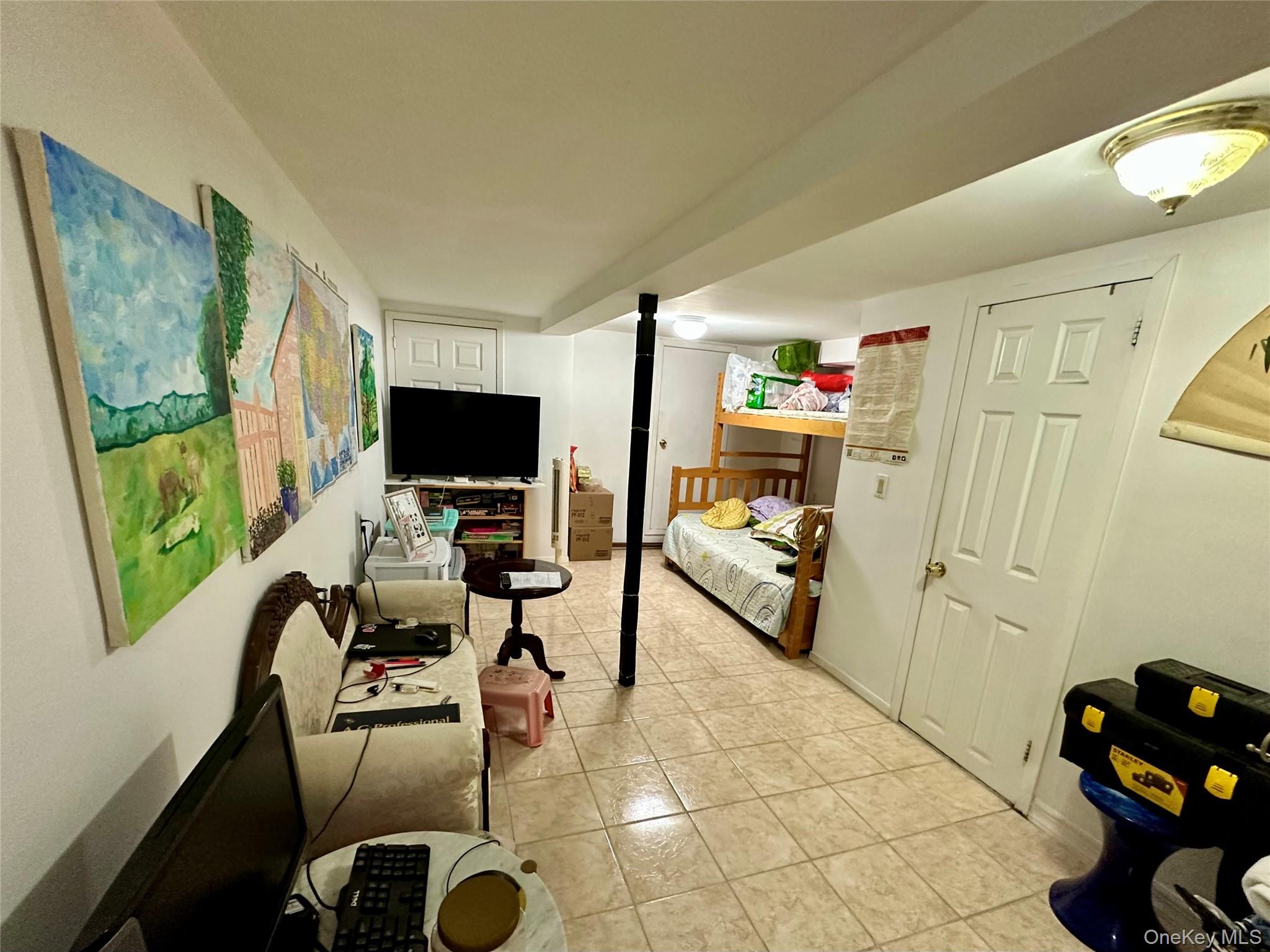90-11 75th Street Queens, NY 11421 - Photo 5 of 9 a living room with furniture and a flat screen tv