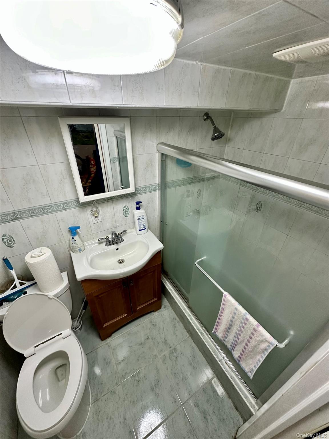 90-11 75th Street Queens, NY 11421 - Photo 6 of 9 a bathroom with a sink and mirror