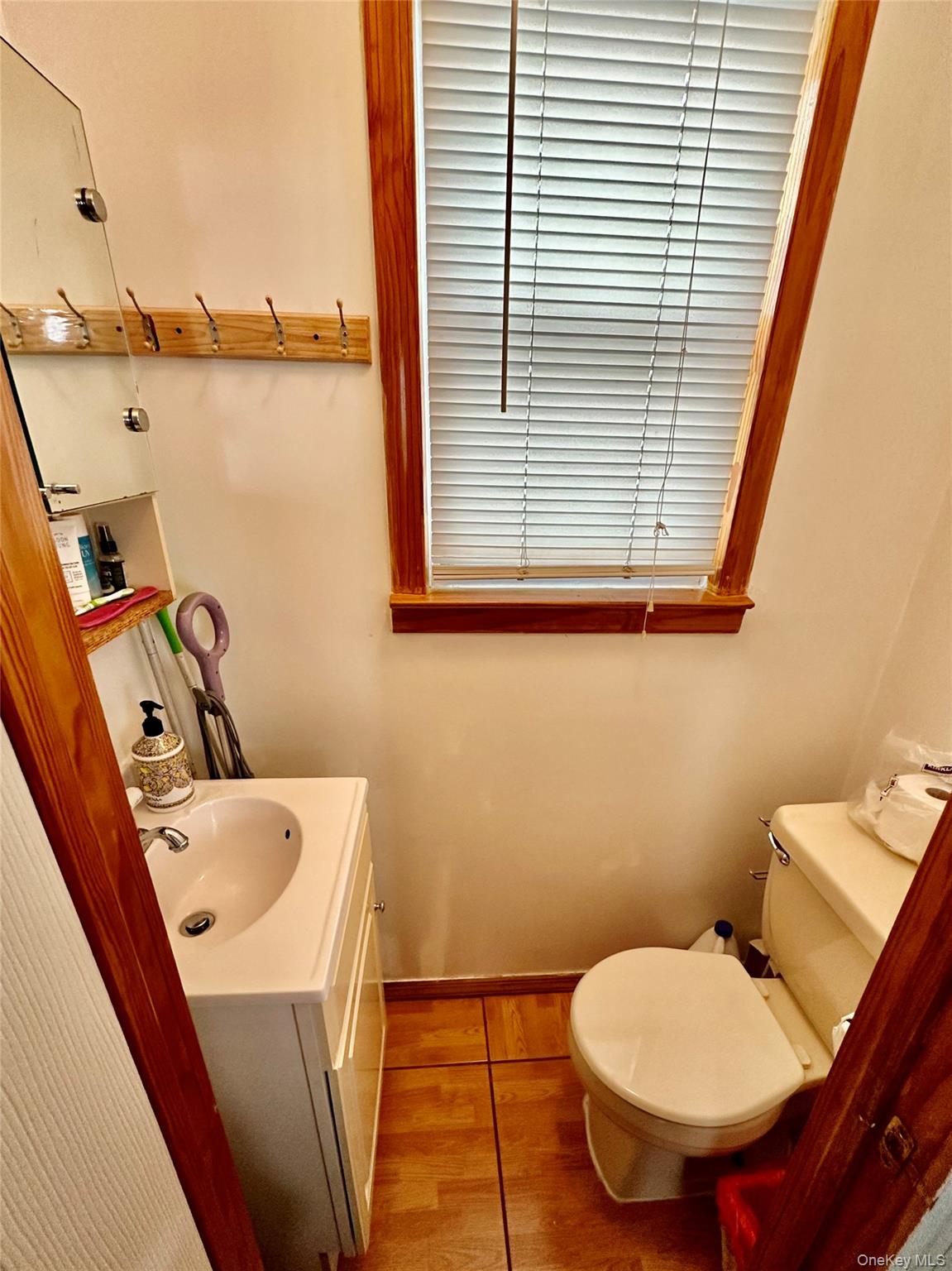 90-11 75th Street Queens, NY 11421 - Photo 7 of 9 a bathroom with a toilet sink and mirror