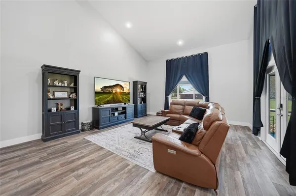 a living room with kitchen island furniture and a wooden floor
