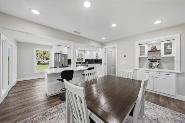 a large kitchen with a table and chairs