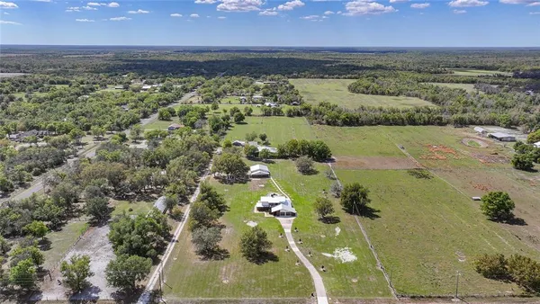 an aerial view of a house with outdoor space