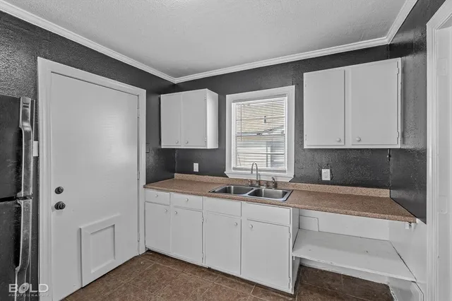 a kitchen with a sink and cabinets