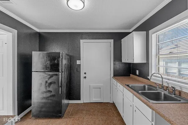 a kitchen with a refrigerator and a sink