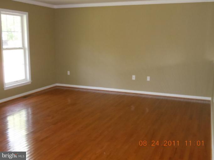 9065 Rixeyville Road Rixeyville, VA 22737 - Photo 10 of 12 a view of an empty room with wooden floor and a window