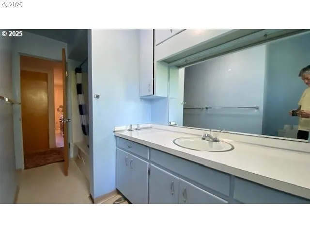 a bathroom with a sink and a mirror