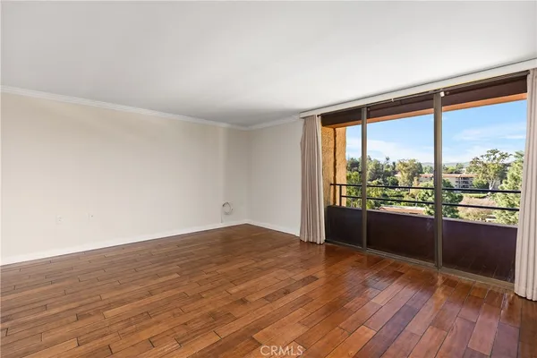 a view of kitchen with furniture and wooden floor
