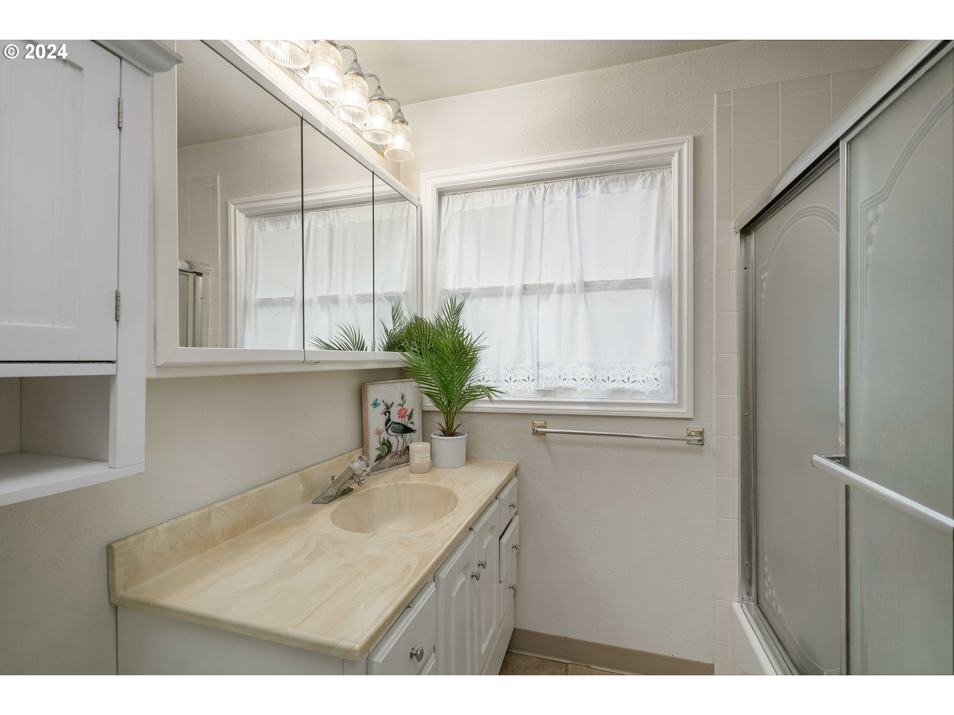4425 Southwest Dosch Road Portland, OR 97239 - Photo 23 of 40 a bathroom with a granite countertop sink a mirror and a shower
