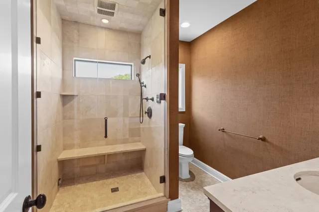 a bathroom with a sink toilet and shower