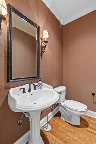 a bathroom with a sink a toilet and mirror