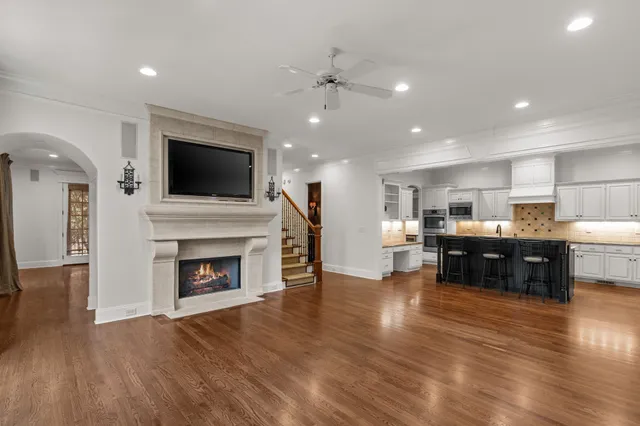 a kitchen with stainless steel appliances granite countertop a table chairs sink and cabinets