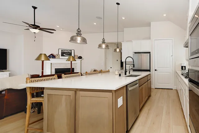 a kitchen with kitchen island a sink appliances and a counter top space