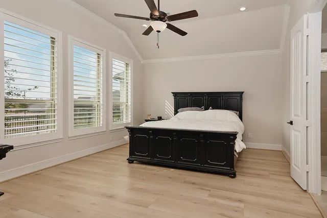 a bed sitting in a bedroom next to a window