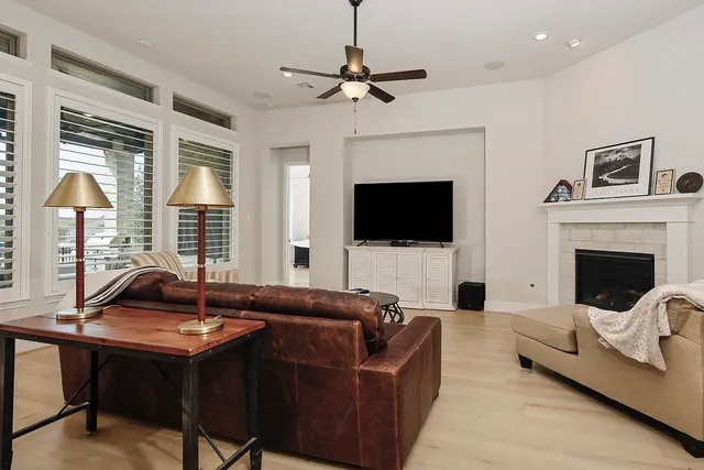 a living room with furniture fireplace and flat screen tv