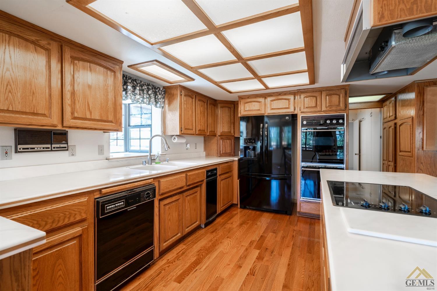 Undisclosed Address Tehachapi, CA 93561 - Photo 13 of 44 a large kitchen with stainless steel appliances granite countertop a stove and a refrigerator