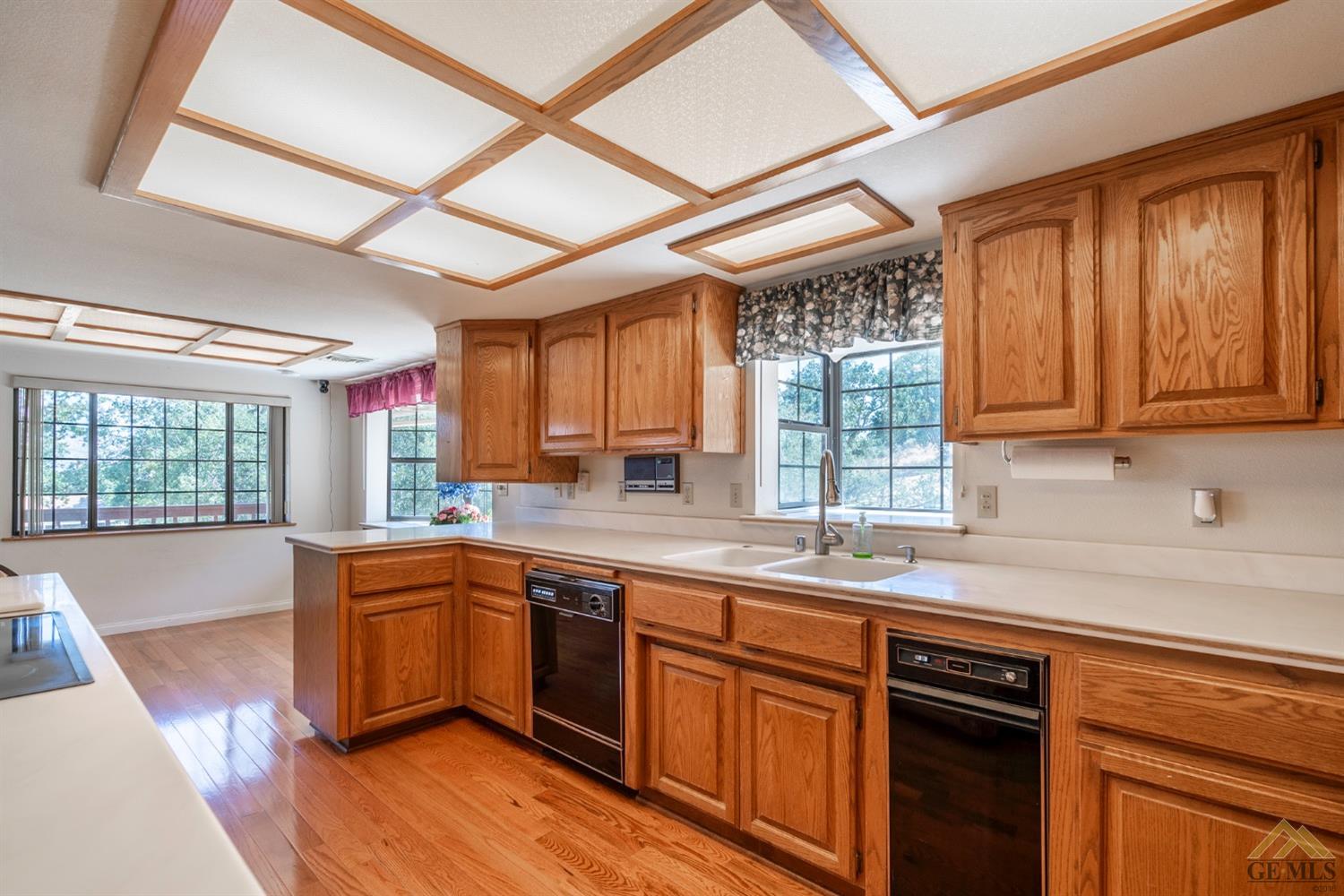 Undisclosed Address Tehachapi, CA 93561 - Photo 14 of 44 a kitchen with stainless steel appliances granite countertop wooden cabinets a sink and dishwasher a stove with wooden floor