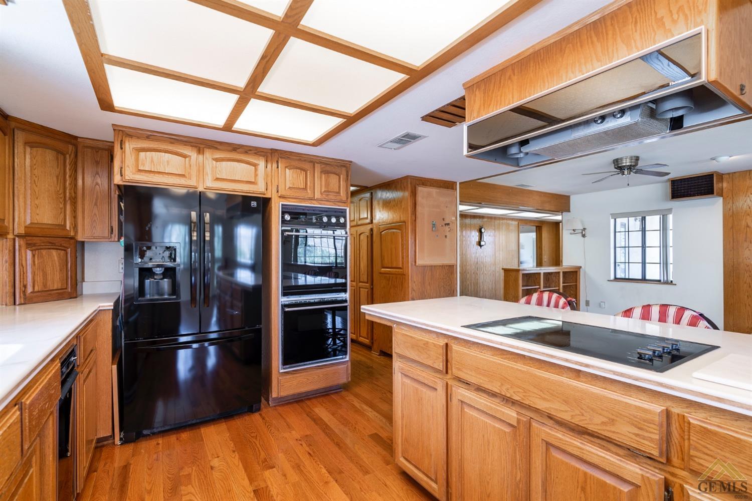 Undisclosed Address Tehachapi, CA 93561 - Photo 15 of 44 a kitchen with stainless steel appliances granite countertop a sink and a refrigerator