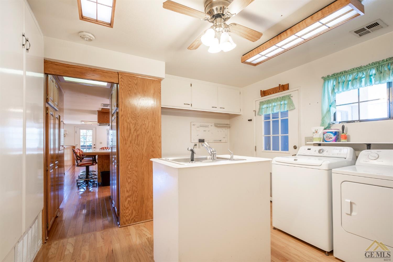 Undisclosed Address Tehachapi, CA 93561 - Photo 20 of 44 a kitchen with kitchen island a stove a sink and a refrigerator