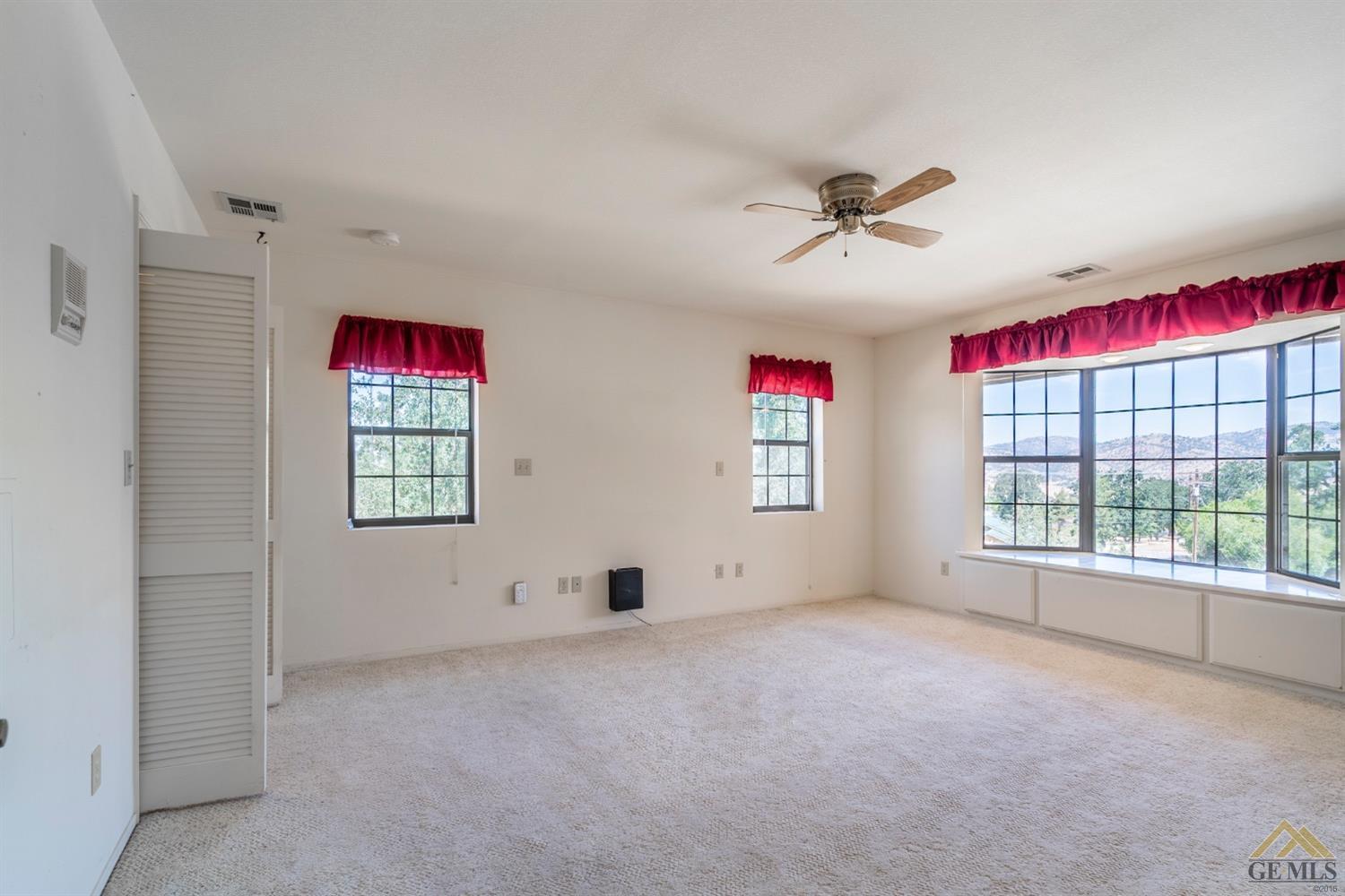 Undisclosed Address Tehachapi, CA 93561 - Photo 25 of 44 an empty room with windows and fan