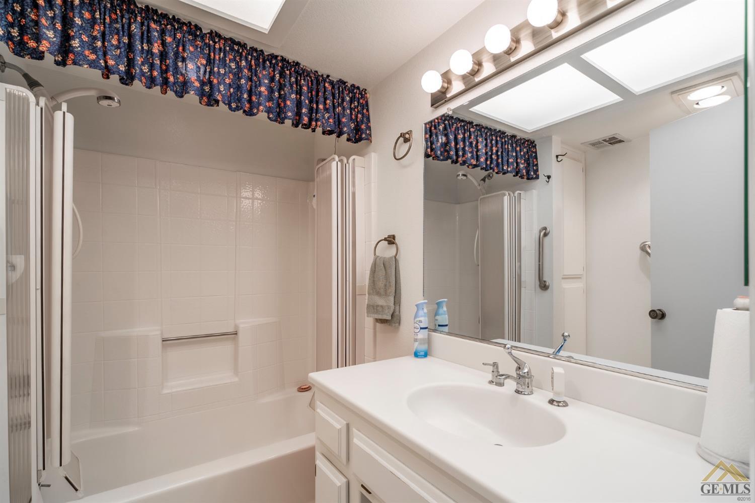 Undisclosed Address Tehachapi, CA 93561 - Photo 33 of 44 a bathroom with a sink a mirror and a bathtub