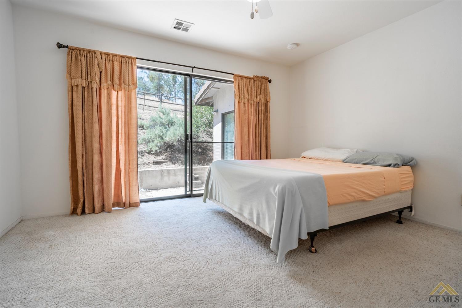 Undisclosed Address Tehachapi, CA 93561 - Photo 34 of 44 a bed sitting in a spacious bedroom next to a window