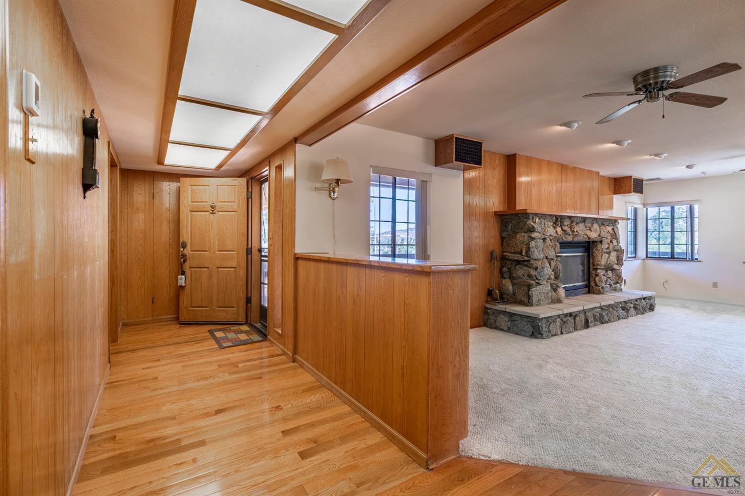 Undisclosed Address Tehachapi, CA 93561 - Photo 4 of 44 a view of a hallway with wooden floor and staircase