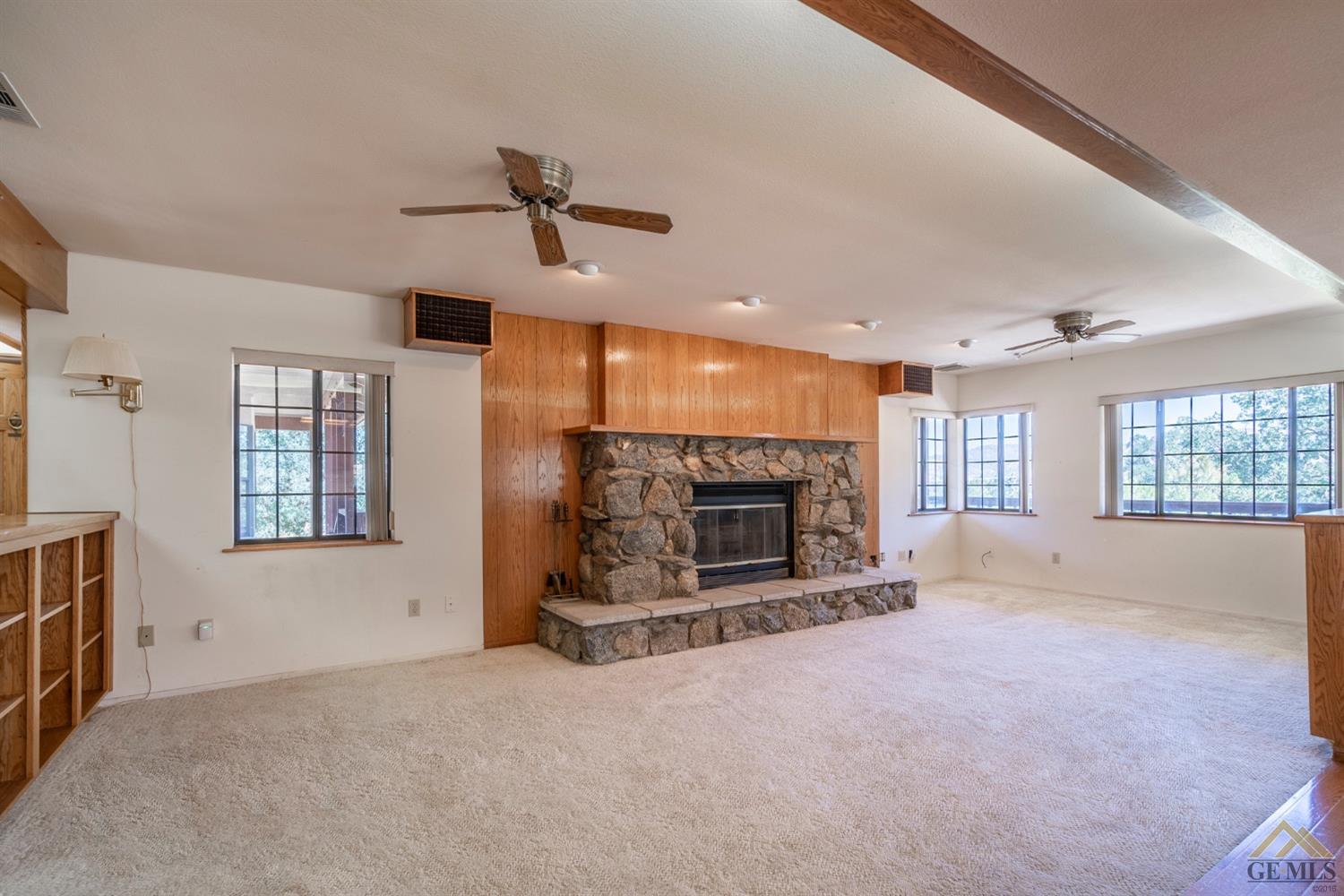 Undisclosed Address Tehachapi, CA 93561 - Photo 6 of 44 a view of an empty room with a fireplace and a window
