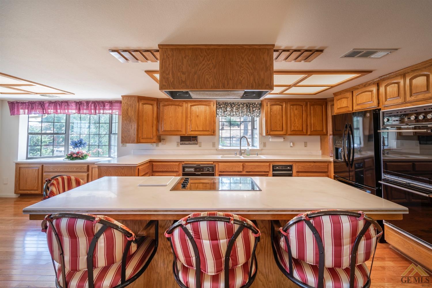 Undisclosed Address Tehachapi, CA 93561 - Photo 9 of 44 a kitchen with stainless steel appliances granite countertop a sink a stove and a wooden cabinets