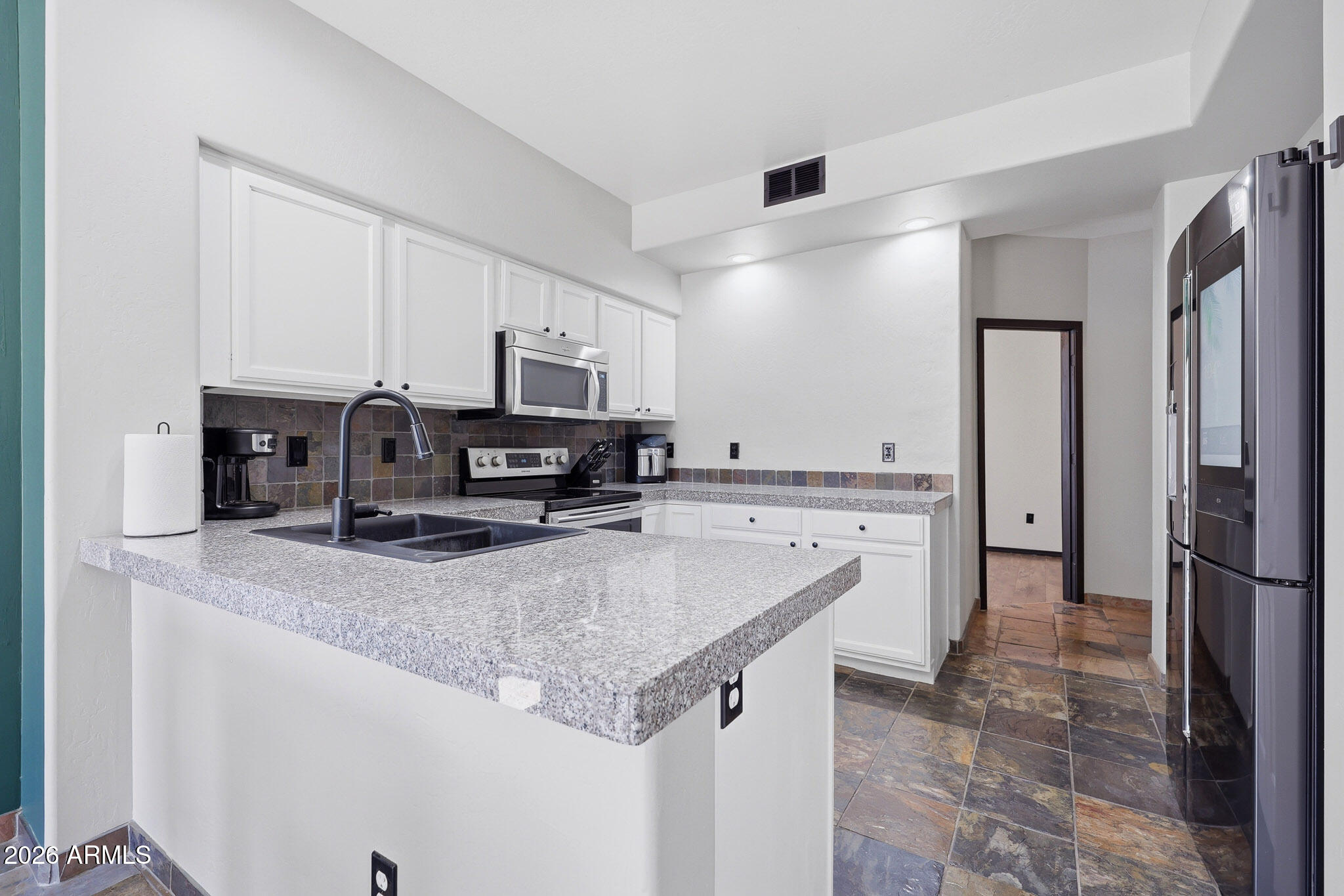 2167 East Nighthawk Way Phoenix, AZ 85048 - Photo 3 of 28 a kitchen with stainless steel appliances granite countertop a sink stove and refrigerator