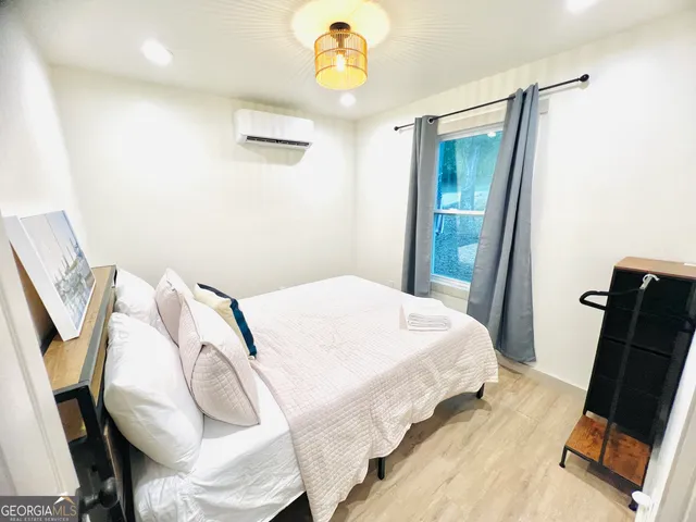 a bedroom with a bed and a window