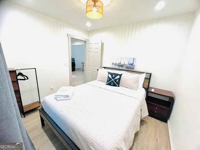 a bed room with a bed and a mirror