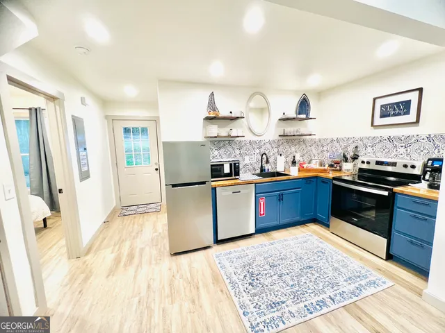 a kitchen with stainless steel appliances granite countertop a stove sink and cabinets