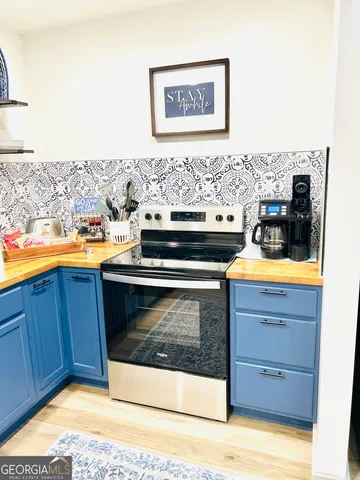 a view of a kitchen with a stove top oven
