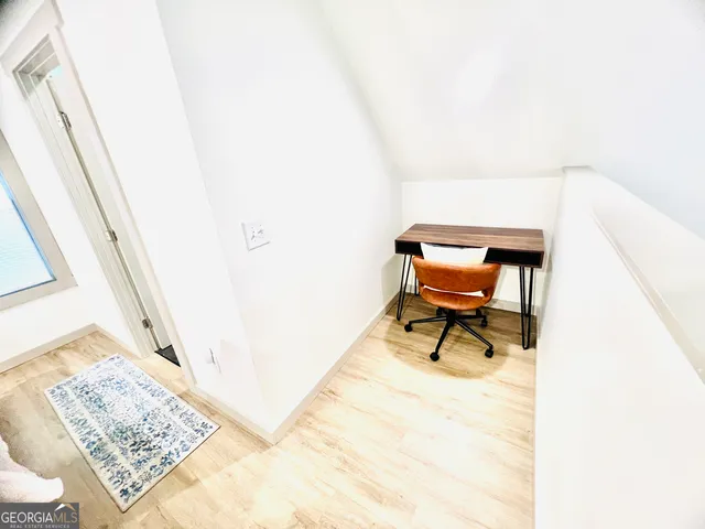 a reading room with furniture and rug