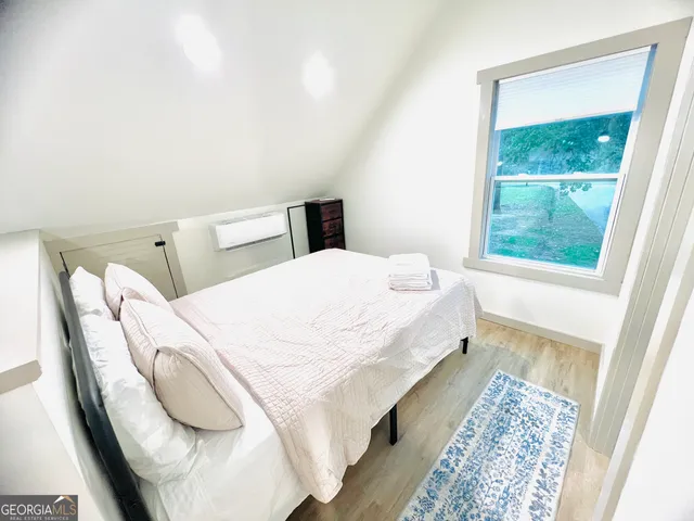 a large white bed in a white room
