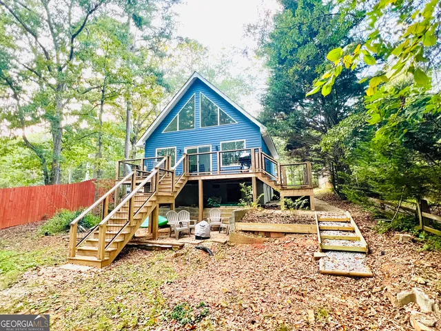 a view of a house with backyard porch and sitting area