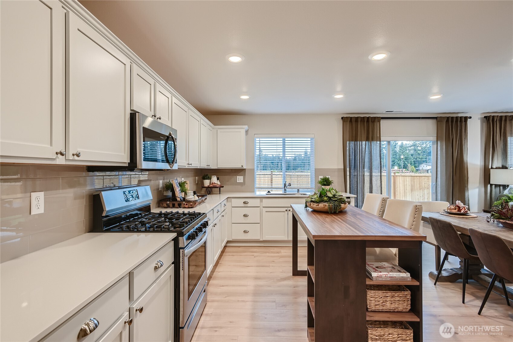 1212 15th Avenue Sultan, WA 98294 - Photo 6 of 19 a kitchen with stainless steel appliances a stove a sink a cabinets and a refrigerator