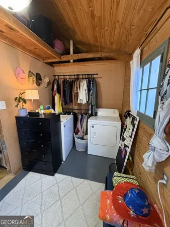 a bedroom with furniture and a flat screen tv