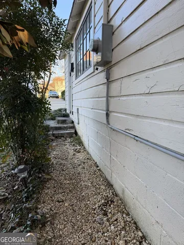 a front view of a house with plants