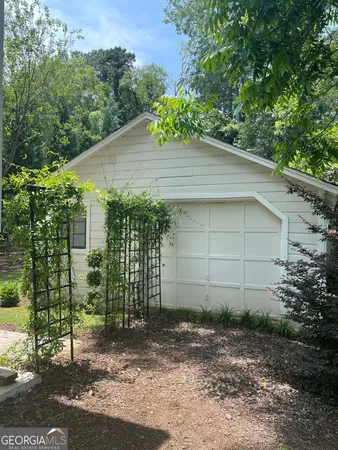 front view of a house with a yard and potted plants