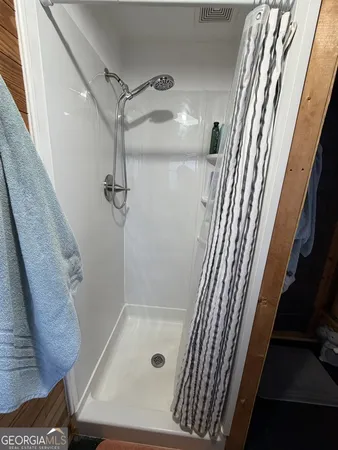 a bathroom with a tub and shower