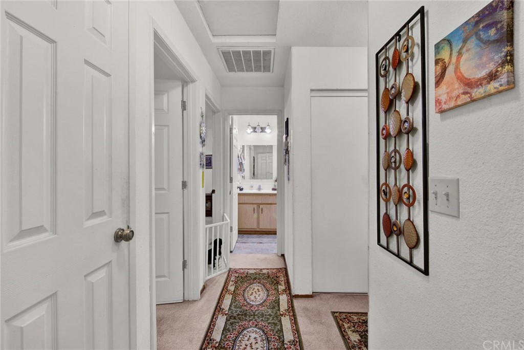 631 North Street Corning, CA 96021 - Photo 17 of 45 a view of a hallway with paintings on the wall