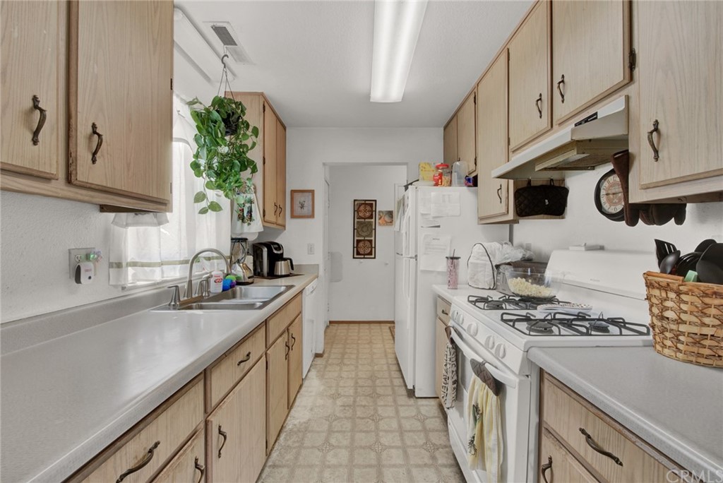 631 North Street Corning, CA 96021 - Photo 23 of 45 a kitchen with stainless steel appliances a sink a stove a refrigerator a sink a counter space and cabinets