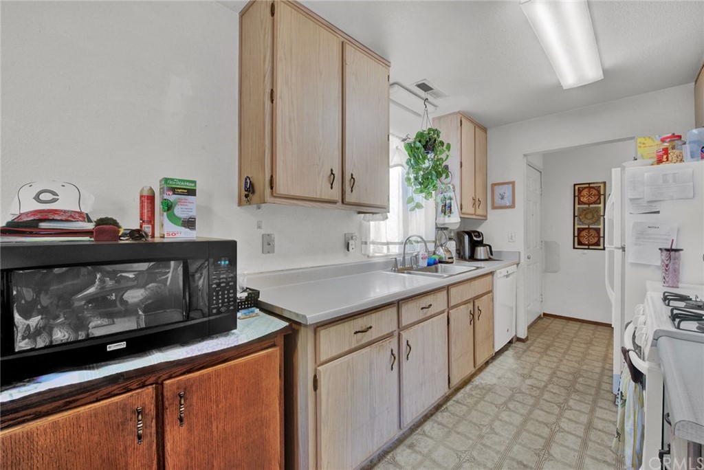 631 North Street Corning, CA 96021 - Photo 24 of 45 a kitchen with stainless steel appliances a sink a stove and a refrigerator