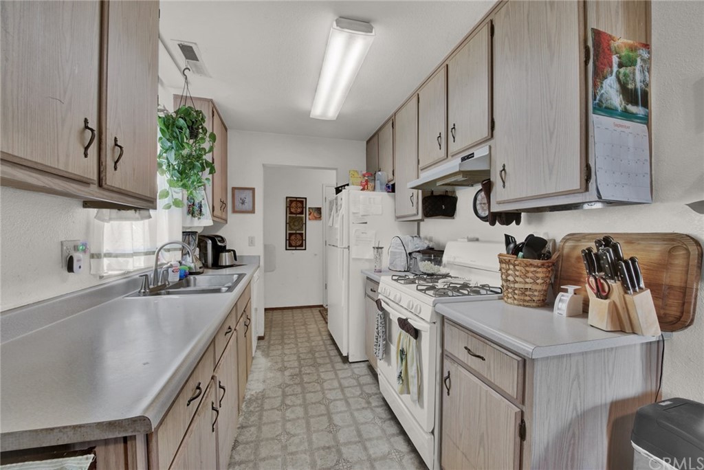 631 North Street Corning, CA 96021 - Photo 25 of 45 a kitchen with stainless steel appliances granite countertop a sink stove and refrigerator