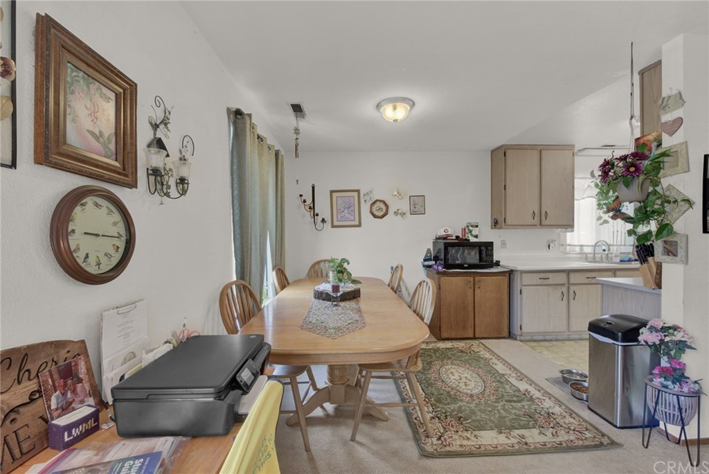 631 North Street Corning, CA 96021 - Photo 27 of 45 a kitchen with a table chairs a stove and cabinets