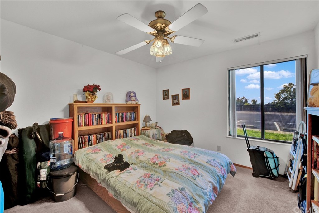 631 North Street Corning, CA 96021 - Photo 32 of 45 a bedroom that has a bed and a bookshelf in it