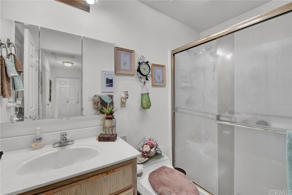 631 North Street Corning, CA 96021 - Photo 33 of 45 a bathroom with a sink vanity mirror and toilet